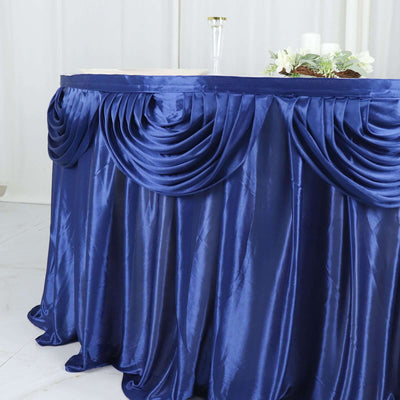 Elegant navy blue table skirt with pleated design for events or decorations.
