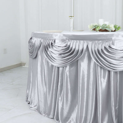 Silver tablecloth with elegant draping for events and celebrations.