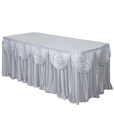 White satin tablecloth with elegant draping for events or weddings