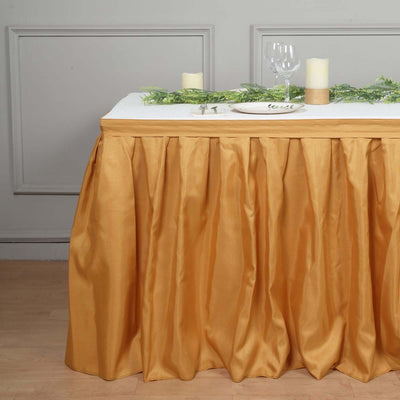 Elegant gold table skirt with pleats for special occasions.