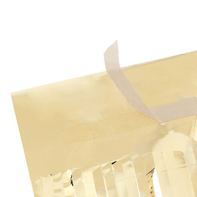 Gold foil decorative sheet with fringed edges and adhesive tape.
