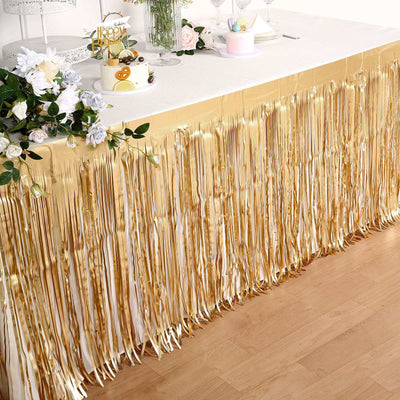 Gold fringe table skirt for party decoration, ideal for festive events.