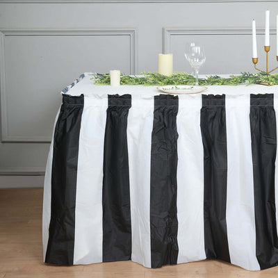 Black and white striped table skirt for events and celebrations.