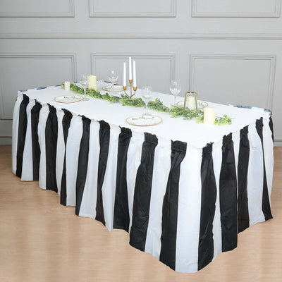 Black and white striped table skirt for festive events and decorations.
