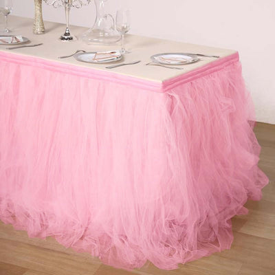 Pink tulle table skirt for elegant party decor.