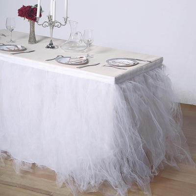 White tulle table skirt with elegant dining setup and decorations