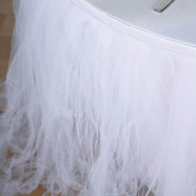 White tulle table skirt with a soft, flowing texture.