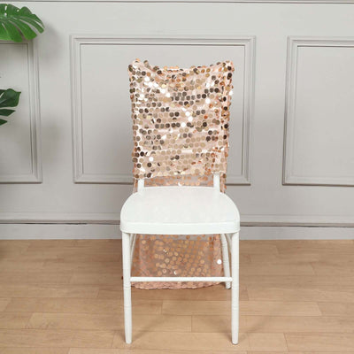 Rose gold sequin chair cover on a white chair in a styled setting.