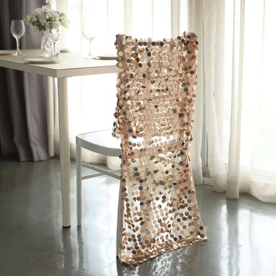 Decorative chair cover in soft tones draped over a white chair in a bright room.