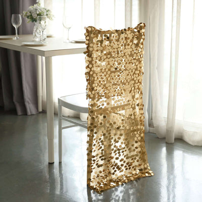Gold sequin chair cover draped over a white chair in a dining setting.