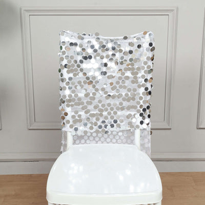 Sequin chair cover with silver and white dots on a white chair.