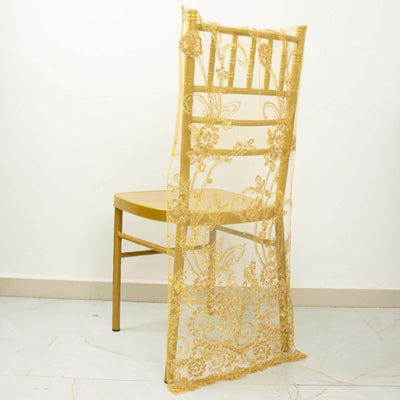 Gold lace chair back cover on a wooden chair against a plain background.
