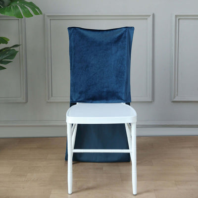 Navy blue chair cover on a white chair in a stylish interior setting.