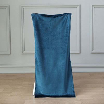 Teal velvet chair cover draped over a chair against a plain background.