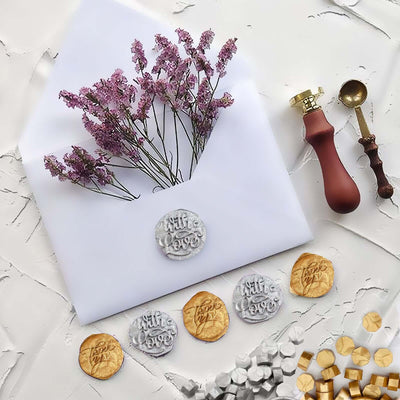 Wax seals and dried flowers on an envelope for elegant stationery styling.