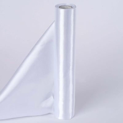 Shiny white satin ribbon roll on a plain backdrop