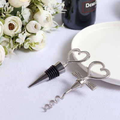 Heart-shaped wine bottle opener and stopper set on a table with flowers.