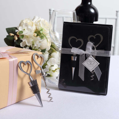 Heart-shaped wine bottle stopper and corkscrew gift set in elegant packaging.