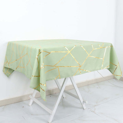 Green tablecloth with gold geometric pattern on a white table