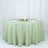 Round green tablecloth with gold geometric design on a banquet table.