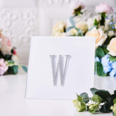 Rhinestone letter "W" decorative initial on a white background.