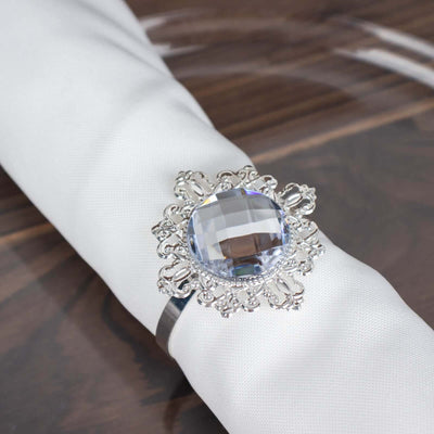 Elegant silver napkin ring with a large crystal centerpiece.