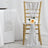 Silver sequin chair sash with flower decoration on a gold chair.