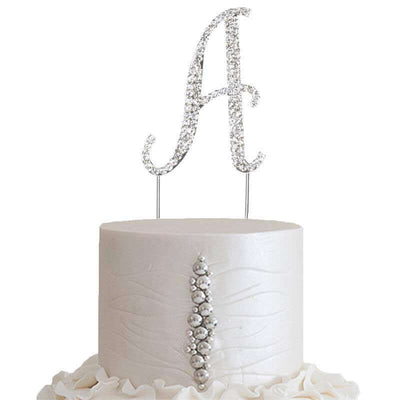 Elegant silver rhinestone letter "A" cake topper on a white cake.
