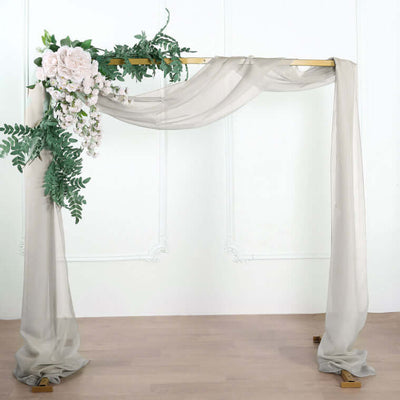 Elegant wedding arch with draped fabric and floral accents.