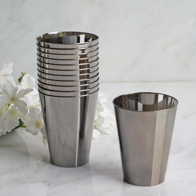 Set of stainless steel cups stacked with one cup beside them