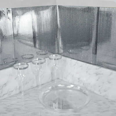 Elegant glassware set on a marble counter with mirrored backdrop.
