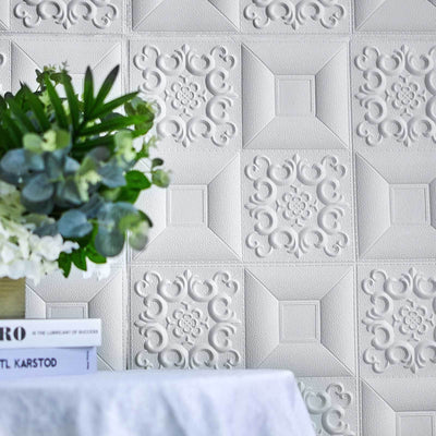 Textured white wall panel with floral design and decorative accents.