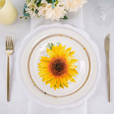 Sunflower plate on a table setting with gold cutlery and floral centerpiece.