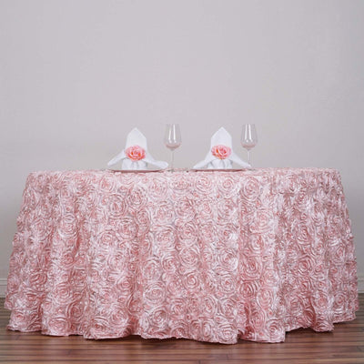 Pink rose-patterned tablecloth draped over a table with glasses and napkins.