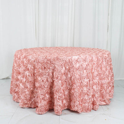 Pink rose-patterned tablecloth on a round table in a studio setting.