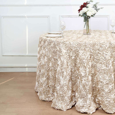 Elegant rose-patterned tablecloth draped over a round table with floral centerpiece.