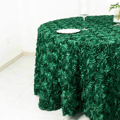 Green rose-patterned tablecloth draping over a round table.