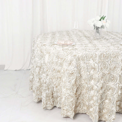 Elegant rose-patterned tablecloth on a round table with floral centerpiece.