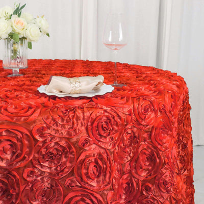 Red rose patterned tablecloth with elegant napkin and glass of wine.