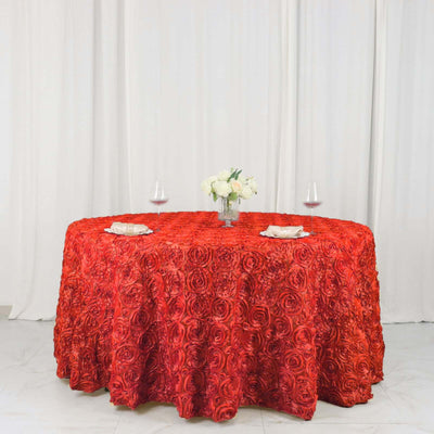 Red rose-patterned tablecloth elegantly draped on a round table with floral centerpiece.