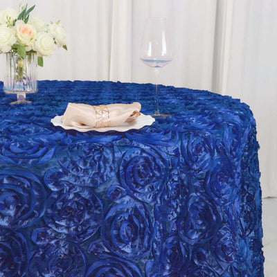 Blue rose-patterned tablecloth with elegant napkin and glass of wine on a table.