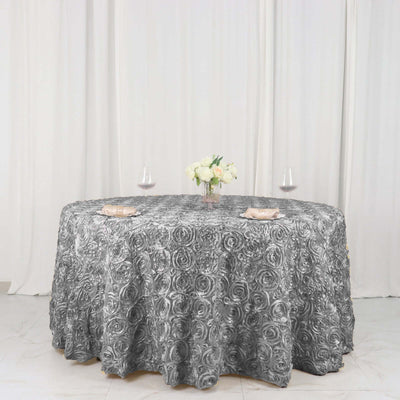Elegant gray rose-patterned tablecloth on a round table with floral centerpiece.