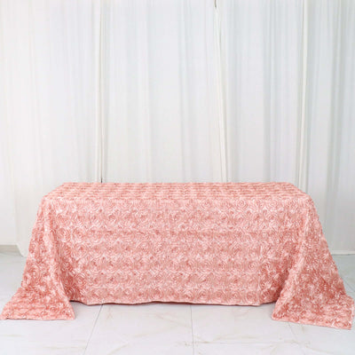 Pink rose-patterned tablecloth on a plain backdrop.