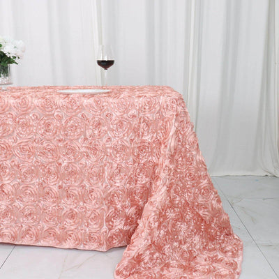 Pink rose-patterned tablecloth draped elegantly on a table with a glass of wine.