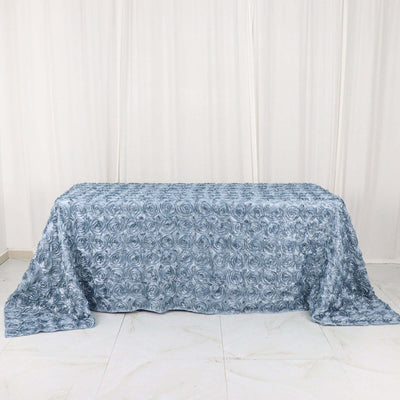 Blue rose-patterned tablecloth draped over a table.