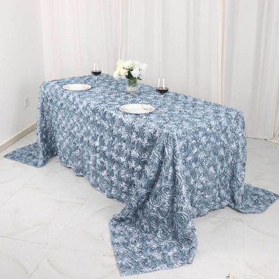 Blue floral tablecloth draped over a table set for dining.
