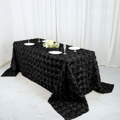 Elegant black rose-patterned tablecloth on a dining table.