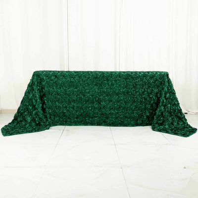 Green rose-patterned tablecloth on a plain backdrop.