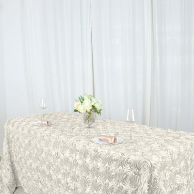 Elegant cream tablecloth on a dining table with floral centerpiece and wine glasses.