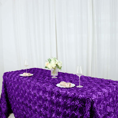 Purple rose textured tablecloth with elegant table setting and floral centerpiece.